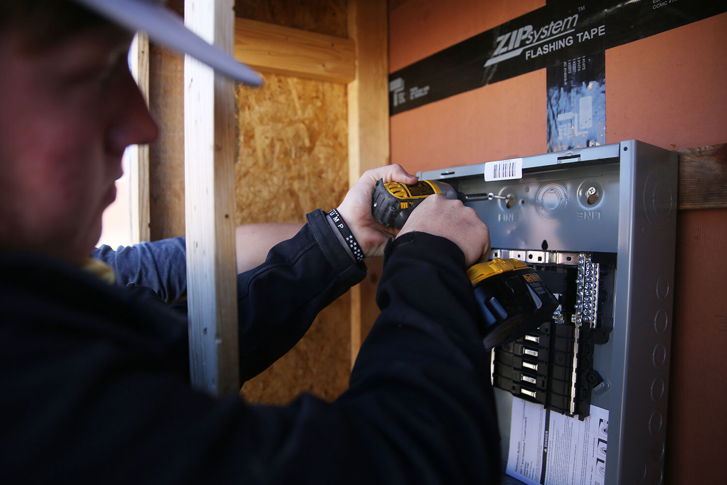 Brandon Sweeney drills in what will eventually be the fuse box